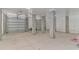 Large garage area with concrete pillars, roller doors, and bright lighting at 89 Enclave Pl., Pawleys Island, SC 29585