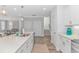 Bright kitchen view with a large kitchen island, white cabinets, stainless appliances, and hardwood flooring at 89 Enclave Pl., Pawleys Island, SC 29585