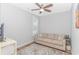 Cozy living room with a comfortable beige sofa, patterned rug, and a ceiling fan at 89 Enclave Pl., Pawleys Island, SC 29585