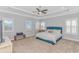 Serene main bedroom with a plush bed, tray ceiling, and plantation shutters at 89 Enclave Pl., Pawleys Island, SC 29585