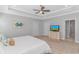 Spacious main bedroom with neutral tones, tray ceiling, and an adjacent ensuite at 89 Enclave Pl., Pawleys Island, SC 29585