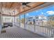 Comfortable outdoor seating on a covered porch with a stained-wood ceiling and neighborhood views at 89 Enclave Pl., Pawleys Island, SC 29585