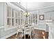 Inviting breakfast nook with hardwood floors, plantation shutters, and stylish lighting fixture at 900 Berwick Ln., Myrtle Beach, SC 29579