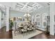 Elegant dining room with coffered ceiling, chandelier, hardwood floors, and formal seating arrangement at 900 Berwick Ln., Myrtle Beach, SC 29579