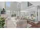 Sunlit living room boasts an open floor plan leading to kitchen and a view of the pool at 900 Berwick Ln., Myrtle Beach, SC 29579