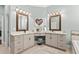 The main bathroom includes and sinks with vanity, tiled floor, and decorative mirror at 900 Berwick Ln., Myrtle Beach, SC 29579