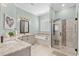 This is the main bathroom with tiled floor, separate shower, vanity, garden tub and decorative mirror at 900 Berwick Ln., Myrtle Beach, SC 29579