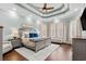 The main bedroom features a tray ceiling with a ceiling fan and is illuminated by natural light from the windows at 900 Berwick Ln., Myrtle Beach, SC 29579