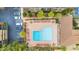 Aerial view of a community pool with lounge chairs, surrounded by lush landscaping and parking at 9501 Shore Dr. # D-234, Myrtle Beach, SC 29572