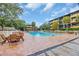 Inviting outdoor pool area featuring comfortable wooden furniture and well-maintained brick decking at 9501 Shore Dr. # D-234, Myrtle Beach, SC 29572