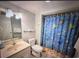 Charming bathroom with a tub-shower combo, a sink with vanity, and marine-themed shower curtain at 9820 Queensway Blvd. # 1502, Myrtle Beach, SC 29572