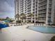 Beautiful outdoor pool and seating at this condo community near lush palm trees at 9820 Queensway Blvd. # 1502, Myrtle Beach, SC 29572