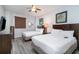 Comfortable bedroom with two beds, a ceiling fan, and modern decor at 100 North Beach Blvd. # 506, North Myrtle Beach, SC 29582