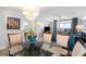 Dining area featuring a chandelier and views into the living room and ocean from the balcony at 100 North Beach Blvd. # 506, North Myrtle Beach, SC 29582