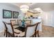 Dining area featuring a glass table, chandelier and decorative art at 100 North Beach Blvd. # 506, North Myrtle Beach, SC 29582