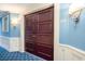 A building entrance with modern lighting, blue walls and dark brown wood paneled doors with room number at 100 North Beach Blvd. # 506, North Myrtle Beach, SC 29582
