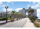 Scenic view of the resort exterior, featuring palm trees lining the road and architecture with skybridge at 100 North Beach Blvd. # 506, North Myrtle Beach, SC 29582