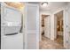 Laundry area featuring a stacked washer and dryer, with views into the bathroom and bedroom at 100 North Beach Blvd. # 506, North Myrtle Beach, SC 29582
