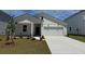 Charming exterior of a bright, white, two-story home with a well-manicured lawn and a two-car garage at 1022 Laconic Dr., Myrtle Beach, SC 29588