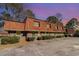 Brick exterior with unique wood roof, green doors, and lots of plants in front of this multi Gathering townhome at 1025 Carolina Rd. # Cc2, Conway, SC 29526