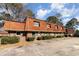 Brick exterior with unique wood roof, green doors, and lots of plants in front of this multi Gathering townhome at 1025 Carolina Rd. # Cc2, Conway, SC 29526