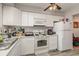 White kitchen features stainless steel appliances, tile backsplash, wood floors and lots of cabinet space at 1025 Carolina Rd. # Cc2, Conway, SC 29526