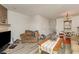 Bright living room with fireplace, hardwood floors, chandelier, door to staircase and entrance to kitchen and dining area at 1025 Carolina Rd. # Cc2, Conway, SC 29526