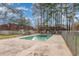 Community pool with a safety fence surrounded by trees and buildings at 1025 Carolina Rd. # Cc2, Conway, SC 29526