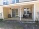 Covered back porch with sliding glass doors, a table, and chairs, perfect for relaxation at 1027 Pinwheel Loop # 3103, Myrtle Beach, SC 29577