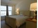 Bright bedroom with a queen-sized bed, bedside tables, and windows that let in natural light at 1027 Pinwheel Loop # 3103, Myrtle Beach, SC 29577