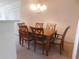 Dining area includes a wood table, six chairs, and a chandelier at 1027 Pinwheel Loop # 3103, Myrtle Beach, SC 29577