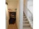 Hallway with a stairwell and storage shelf with items and a storage chest at 1027 Pinwheel Loop # 3103, Myrtle Beach, SC 29577