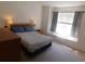 Main bedroom with a bed, two nightstands, and a bright window with gray curtains at 1027 Pinwheel Loop # 3103, Myrtle Beach, SC 29577