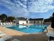 Community pool with lounge chairs and umbrellas, perfect for summer relaxation and recreation at 1027 Pinwheel Loop # 3103, Myrtle Beach, SC 29577