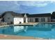 Community pool with clear blue water, lounge chairs, and a clubhouse in the background at 1027 Pinwheel Loop # 3103, Myrtle Beach, SC 29577