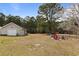 Expansive backyard with a shed, a fire pit seating area, and plenty of space for outdoor activities at 113 Cat Tail Bay Dr., Conway, SC 29527