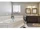Well-lit bathroom with a corner tub, double vanity, and tile flooring provides style and functionality at 113 Cat Tail Bay Dr., Conway, SC 29527