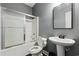 Compact bathroom with a shower-tub combo, a pedestal sink, and a modern black and gray design at 113 Cat Tail Bay Dr., Conway, SC 29527