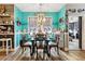 Charming dining room with blue accent walls, wood floors, chandelier, and window with checkered curtains at 113 Cat Tail Bay Dr., Conway, SC 29527
