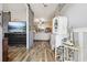 Inviting entryway with wood-look floors, stylish decor, and a glimpse into the living room beyond a decorative sliding barn door at 113 Cat Tail Bay Dr., Conway, SC 29527