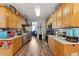 Well-lit kitchen with wood cabinets, neutral countertops, stainless steel appliances, and stylish decor at 113 Cat Tail Bay Dr., Conway, SC 29527