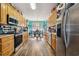 Open-concept kitchen offering stainless steel appliances and wood cabinets, with sight lines to the dining area at 113 Cat Tail Bay Dr., Conway, SC 29527