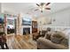 Cozy living room boasts a decorative fireplace, laminate floors, a ceiling fan and comfortable seating at 113 Cat Tail Bay Dr., Conway, SC 29527