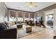Comfortable living room with a large sectional sofa, fireplace, and ample natural light from numerous windows at 113 Cat Tail Bay Dr., Conway, SC 29527