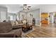 Inviting living room with laminate flooring, comfortable seating, and view to the kitchen separated by a sliding barn door at 113 Cat Tail Bay Dr., Conway, SC 29527