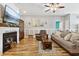 Cozy living room featuring a fireplace, mounted television, ceiling fan, and comfortable seating area at 113 Cat Tail Bay Dr., Conway, SC 29527