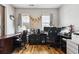 Well-lit office space with dual windows, work stations, dark rolling office chairs and laminate flooring at 113 Cat Tail Bay Dr., Conway, SC 29527