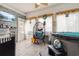 Relaxing sunroom featuring tiled flooring, hot tub, hanging chair, and multiple windows for natural light at 113 Cat Tail Bay Dr., Conway, SC 29527