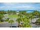 Scenic aerial view of a beachfront community center with an American flag, palm trees, and ocean views at 118 Ellington Ln., Pawleys Island, SC 29585