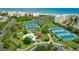 Breathtaking aerial view of a tennis and pool club with tennis courts, swimming pools, and lush green landscaping at 118 Ellington Ln., Pawleys Island, SC 29585